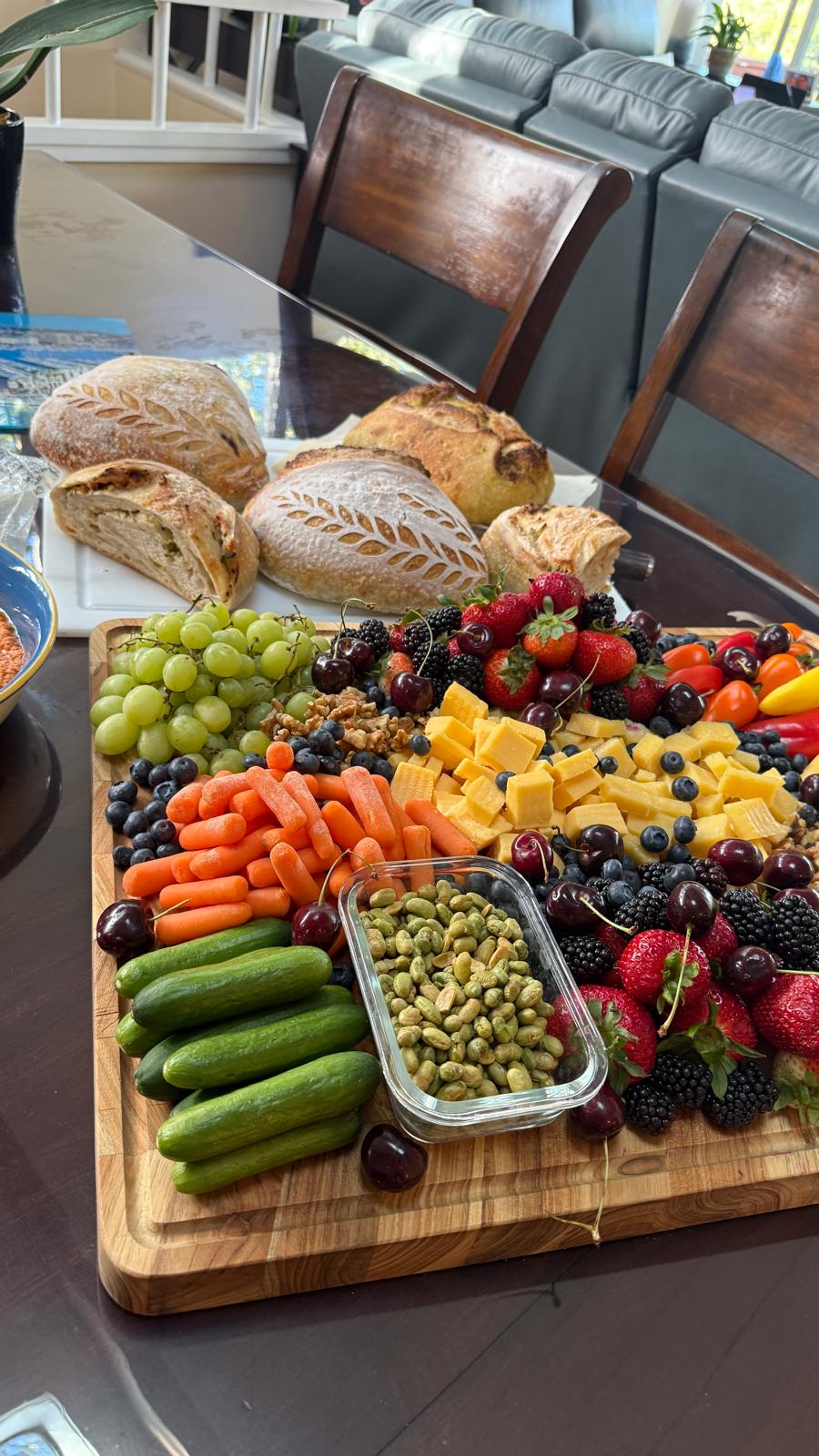 Sourdough loaves alongside a vibrant fruit and cheese board